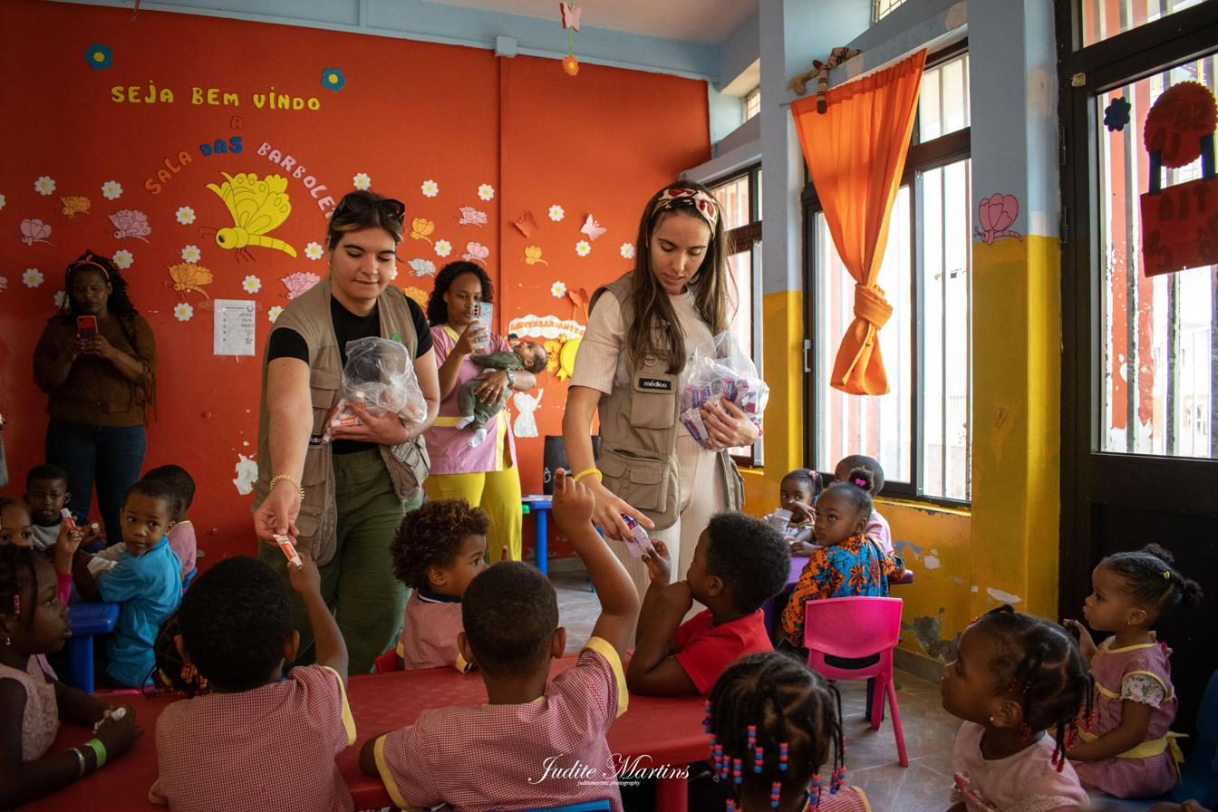 Volunteers handing out kits to children in a kindergarten classroom in Cape Verde